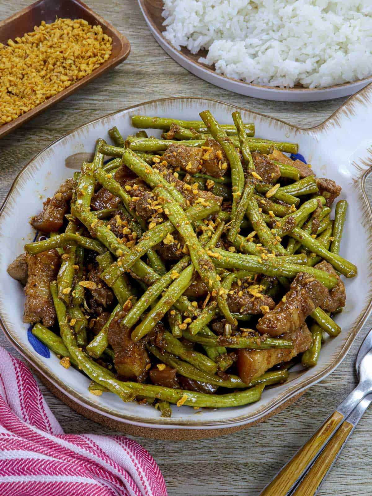 adobong sitaw with pork in a white serving bowl.