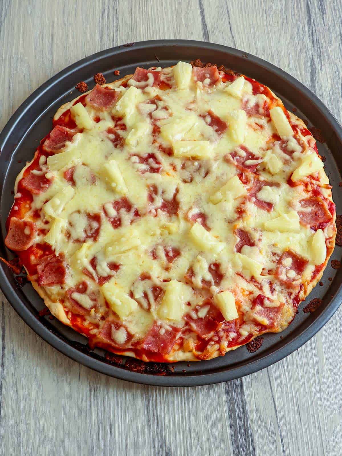freshly baked No-Yeast Hawaiian Pizza on a baking pan.